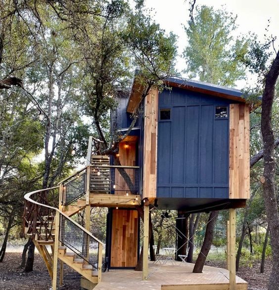 Modern tree house with large windows and wooden deck