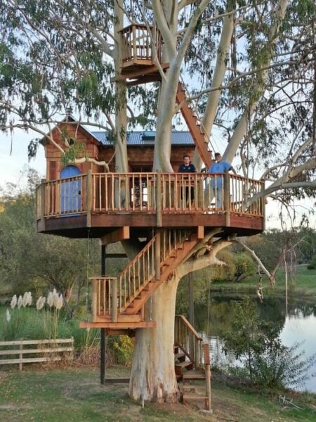 Elevated tiny tree house with rope ladder and balcony