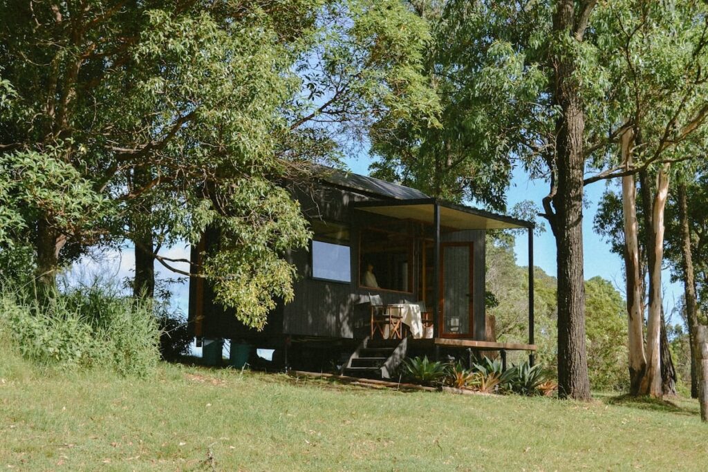 Tiny house in a Brisbane backyard surrounded by greenery