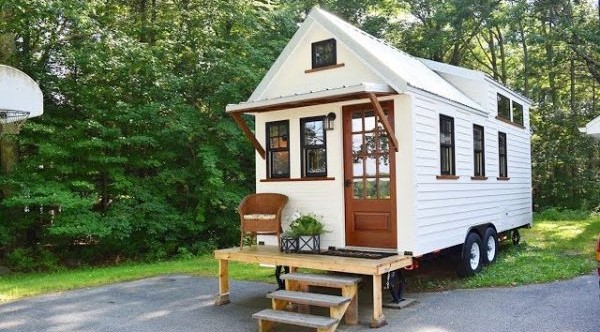 Modern tiny house kit with prefabricated panels on a trailer